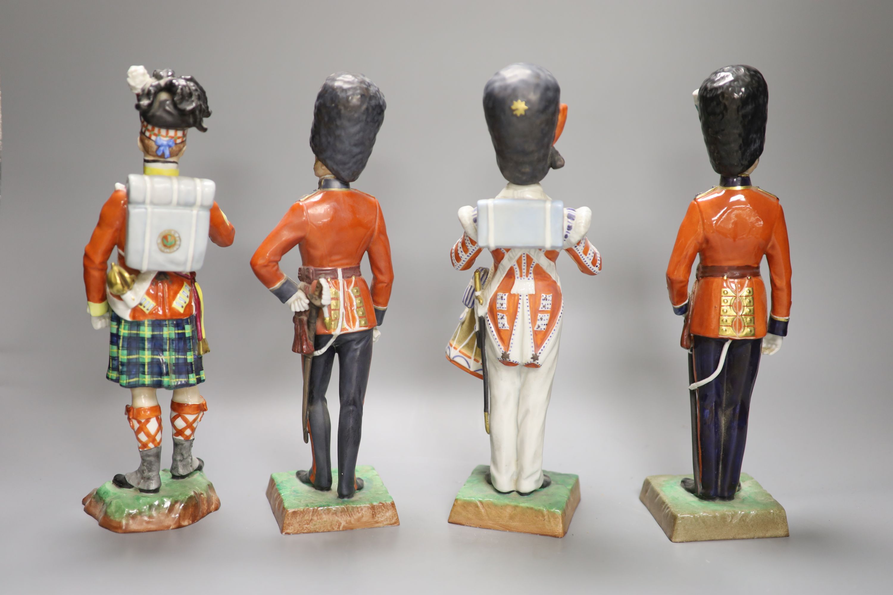 Four Dresden porcelain models of soldiers: Irish Guards, Drummer 3rd Guards, The Welsh Guards and Gordon Highlanders, height 28cm